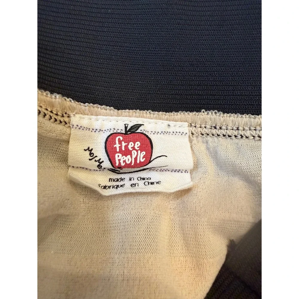 Medium Free People beige ruffle mini skirt thick black elastic waistband.